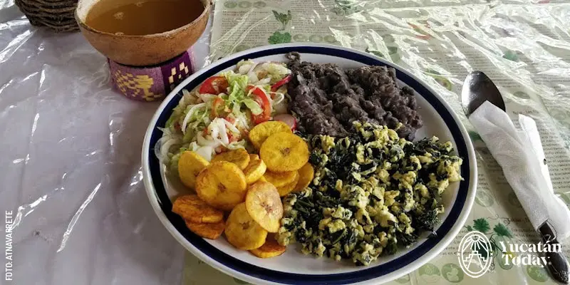 Traditional Yucatecan homemade dish with egg with chaya, beans, plantains, and salad in Maní, Yucatán.